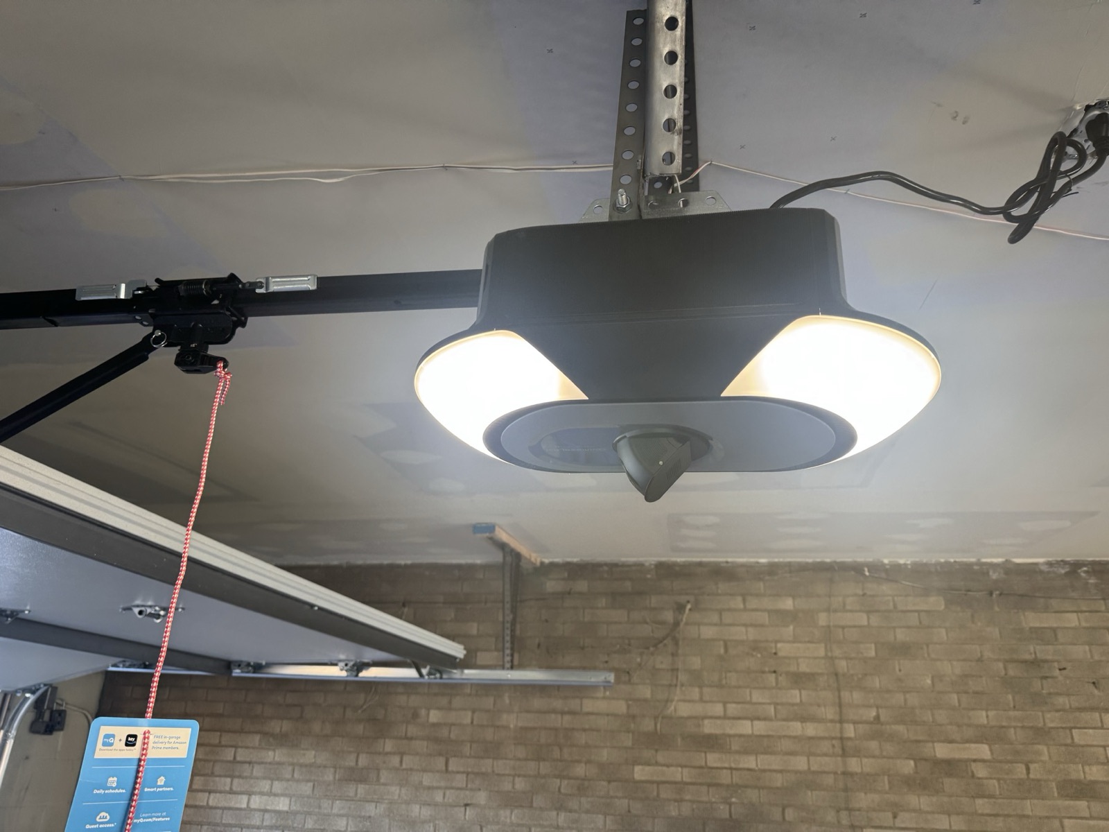 Close-up of a newly installed garage door opener motor unit